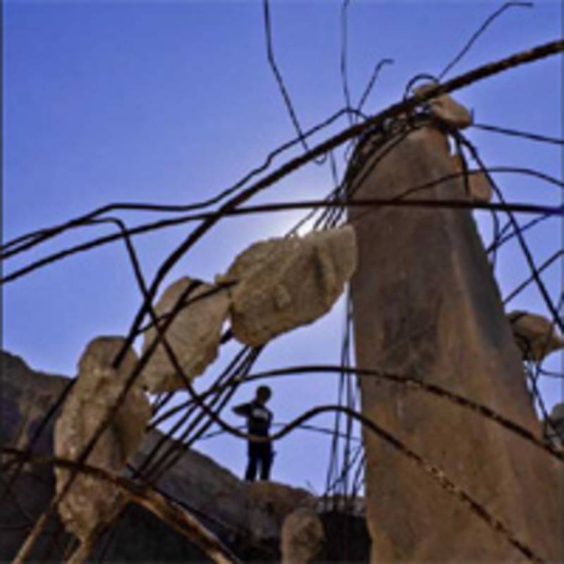 A Palestinian Bedouin standing on the edge of a destroyed well built by the villagers of Umm Al Kheer